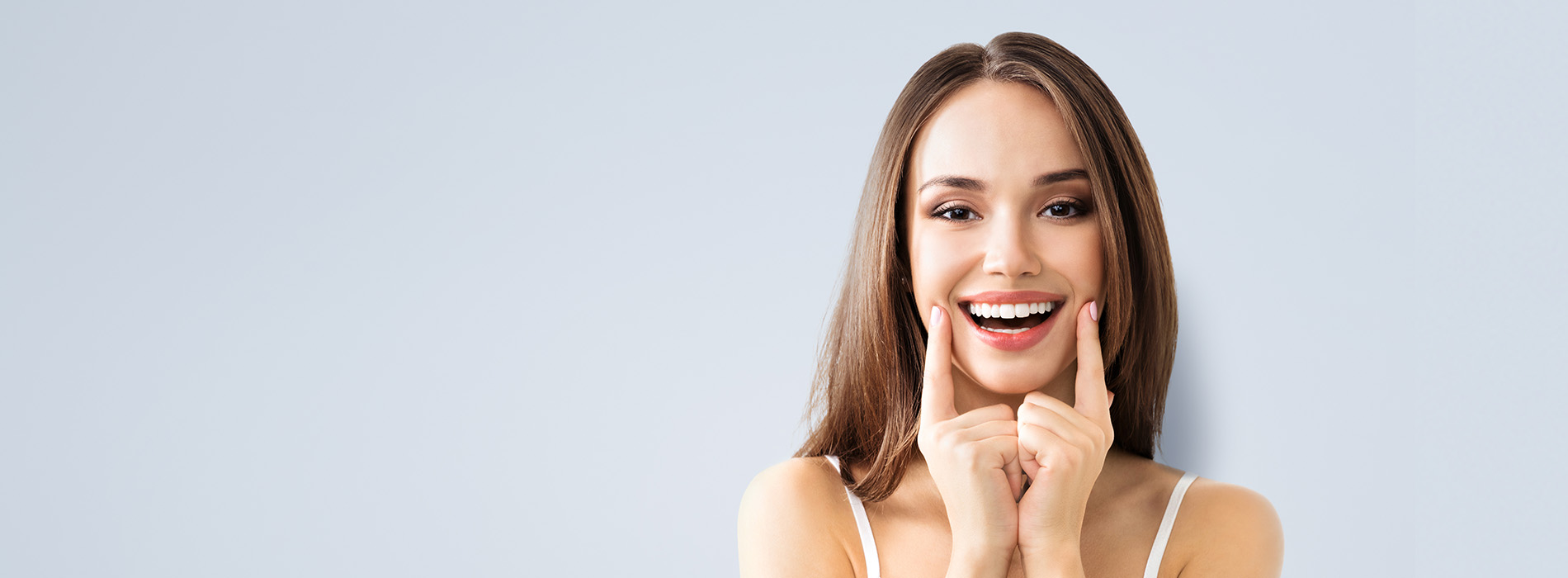 A woman with a surprised expression holds up two fingers.