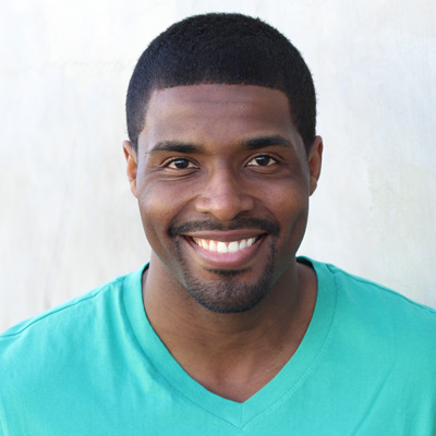 An elderly couple sharing a moment together with smiles on their faces.